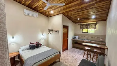 a small bedroom with a bed and a sink at Apartamento los Guanacastes cerca de Tamarindo con piscina in Santa Cruz