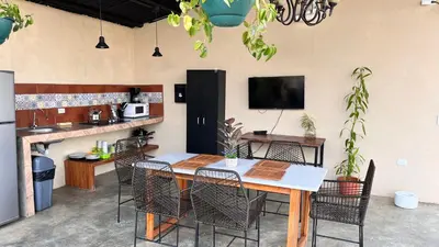 a dining room with a table and chairs at Apartamento los Guanacastes cerca de Tamarindo con piscina in Santa Cruz