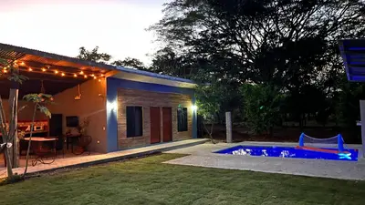 a house with a swimming pool in a yard at Apartamento los Guanacastes cerca de Tamarindo con piscina in Santa Cruz