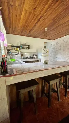 a large kitchen with a large wooden counter top at Twin Palms house in Monteverde Costa Rica