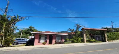 a small pink house on the side of a street at Twin Palms house in Monteverde Costa Rica