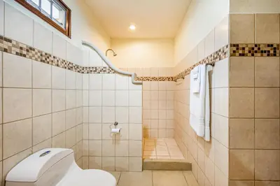 a bathroom with a toilet and a shower at Villa Casiopea in Carpintero
