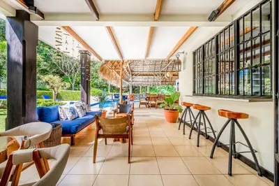 a restaurant with a blue couch and chairs at Villa Casiopea in Carpintero