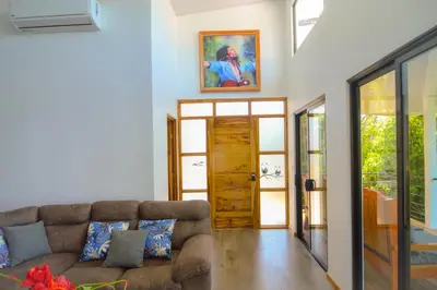 a living room with a couch and a door at Canavida Villas & Resort in Uvita