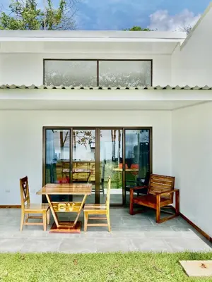 a patio with a table and chairs on a house at Canavida Villas & Resort in Uvita