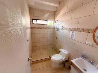 a bathroom with a toilet and a sink at Casa Garitas GuestHouse & Car Rental - Free SJO Airport Shuttle - Nationwide Private Shuttle Services - casagaritas com in Santiago Este