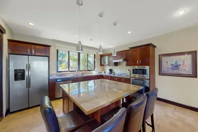a kitchen with a table and chairs and a refrigerator at Azul Paraíso 2B in Ocotal