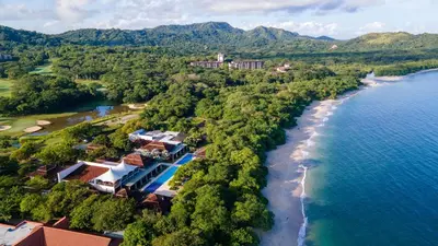 an aerial view of the shoreline of a resort at Luxurious 3BR Ocean-View Condo - Malinche - Reserva Conchal in Playa Conchal