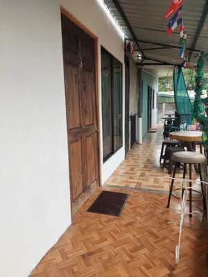 a room with a door and a table and chairs at Anchia - Hostel in Alajuela City