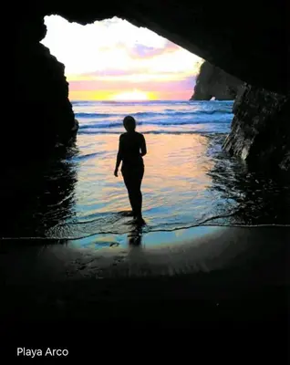 a person walking in the water on a beach at Cabaña Eco-Arte in Tortugal