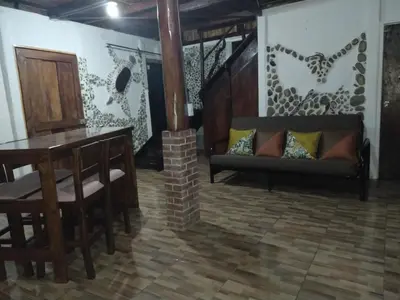 a living room with a couch and a table at Cabaña Eco-Arte in Tortugal