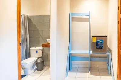 a bathroom with a toilet and a shower at Casa Terra Hostel in Sámara