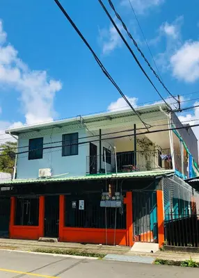 an orange and white building on the corner of a street at Los Sueños IyE 4 in Quepos