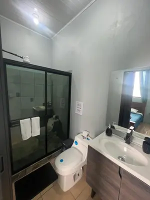 a bathroom with a toilet and a sink at Los Sueños IyE 4 in Quepos