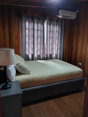 a bed sitting in a room with a window at Your Perfect Home Away From Home! in San Ramón