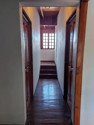 a hallway leading to a room with a window at Your Perfect Home Away From Home! in San Ramón