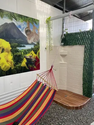 a hammock hanging in a room with a painting at Casita Don Eliber in Fortuna