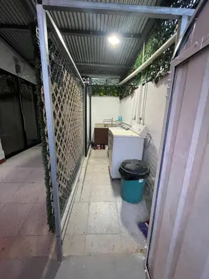 an empty patio with a fence and a trash can at Casita Don Eliber in Fortuna
