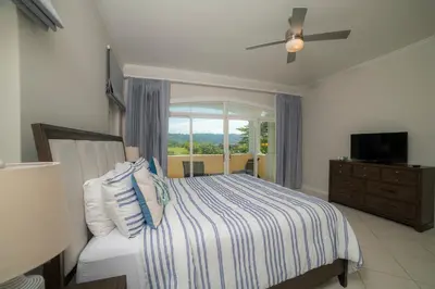 a bedroom with a bed and a window at Colina 7C 3 bdr Garden View in Los Suenos in Herradura