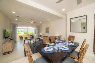 a dining room with a table and chairs at Colina 7C 3 bdr Garden View in Los Suenos in Herradura