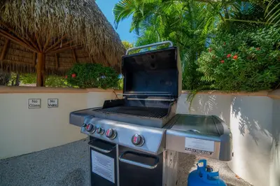 a bbq grill sitting next to a wall at Colina 7C 3 bdr Garden View in Los Suenos in Herradura