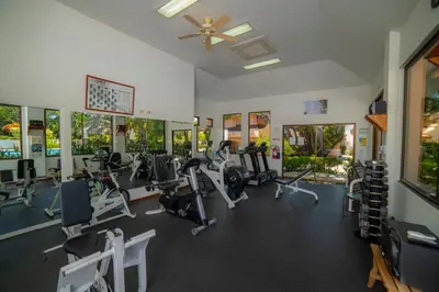 a gym with treadmills and elliptical machines at Colina 7C 3 bdr Garden View in Los Suenos in Herradura