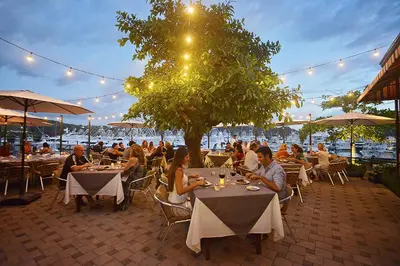 a group of people sitting at tables in a restaurant at Colina 7C 3 bdr Garden View in Los Suenos in Herradura