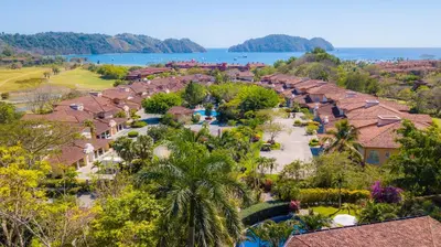 an aerial view of the resort with the ocean in the background at Colina 7C 3 bdr Garden View in Los Suenos in Herradura