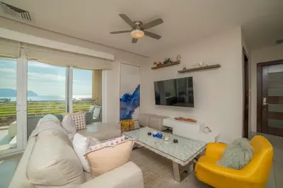 a living room with a couch and a table at Miramar 5D 3 bdr Ocean View in Los Suenos in Herradura