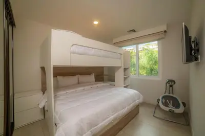 a bedroom with two bunk beds and a window at Miramar 5D 3 bdr Ocean View in Los Suenos in Herradura
