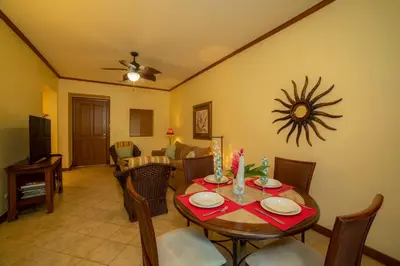 a living room with a table and a dining room at Veranda 5F 2 bdr Garden View in Los Suenos in Herradura