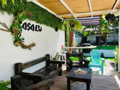 a patio with a bench and chairs and a table at CasaLu in Puntarenas