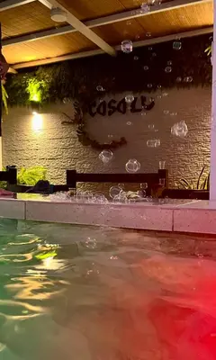 a pool of water with bubbles in front of a brick wall at CasaLu in Puntarenas