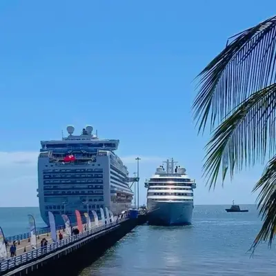 two cruise ships are docked at a dock at CasaLu in Puntarenas