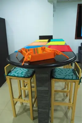 a table with two stools with an orange bag on it at CasaLu in Puntarenas