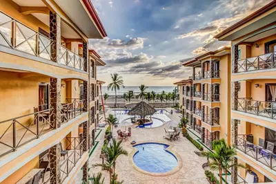 an aerial view of a resort with a swimming pool and the ocean at Bahia Encantada I1 in Jacó