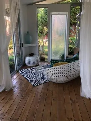 a living room with a hammock on a wooden floor at Villa Ananda in Ballena