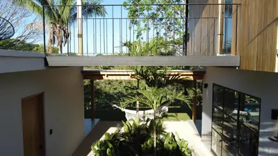 a house with a balcony with plants on it at La Golfina Villa in Santa Teresa Beach