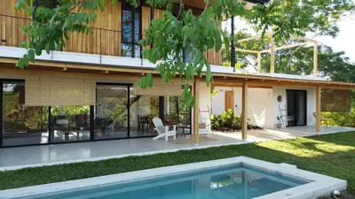 a house with a swimming pool in front of it at La Golfina Villa in Santa Teresa Beach