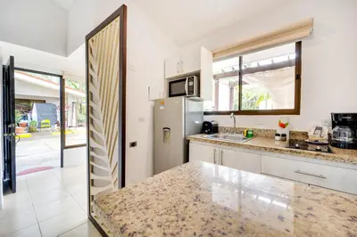 a kitchen with a refrigerator and a counter top at Club Voca #9 in Coco