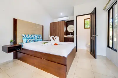 a bedroom with a large bed with a wooden headboard at Club Voca #9 in Coco