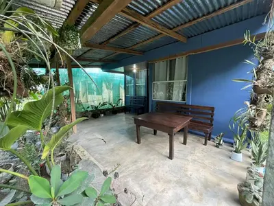 a patio with a wooden table and a bench at Maricel House in San Rafael