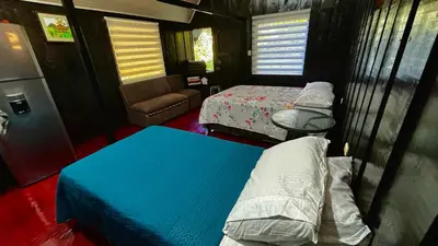 a small room with two beds and a couch at Koi's House - Quebradillas de Dota in Santa María