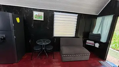 a small room with a chair and a table at Koi's House - Quebradillas de Dota in Santa María