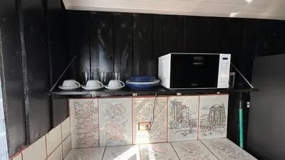 a microwave sitting on top of a shelf at Koi's House - Quebradillas de Dota in Santa María
