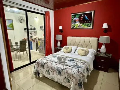 a bedroom with a bed with a stuffed animal on it at Private bedroom 10 minutes from the SJO airport in Alajuela City