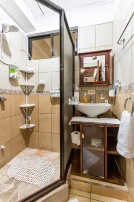 a bathroom with a sink and a shower at Private bedroom 10 minutes from the SJO airport in Alajuela City