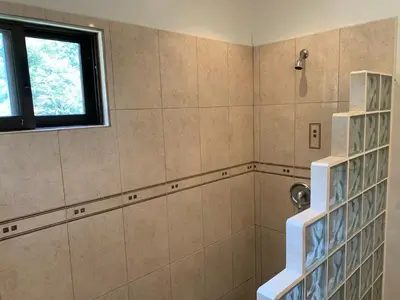 a bathroom with a shower with a window at Toucan Valley Resort at Osa Mountain Village in Agua Buena