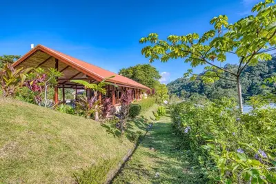 a house on top of a hill with a garden at Toucan Valley Resort at Osa Mountain Village in Agua Buena