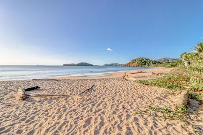 a beach with a bottle on the sand at Casa Carmen in Potrero